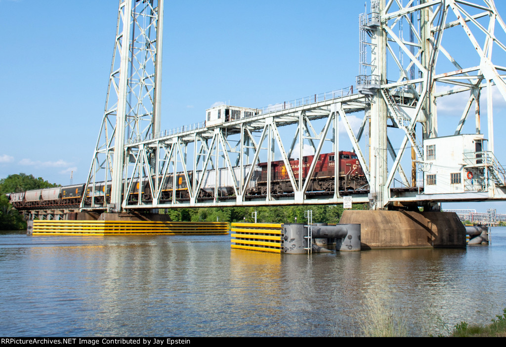 CP 8604 leads a westbound grain train across the Neches River Lift Bridge